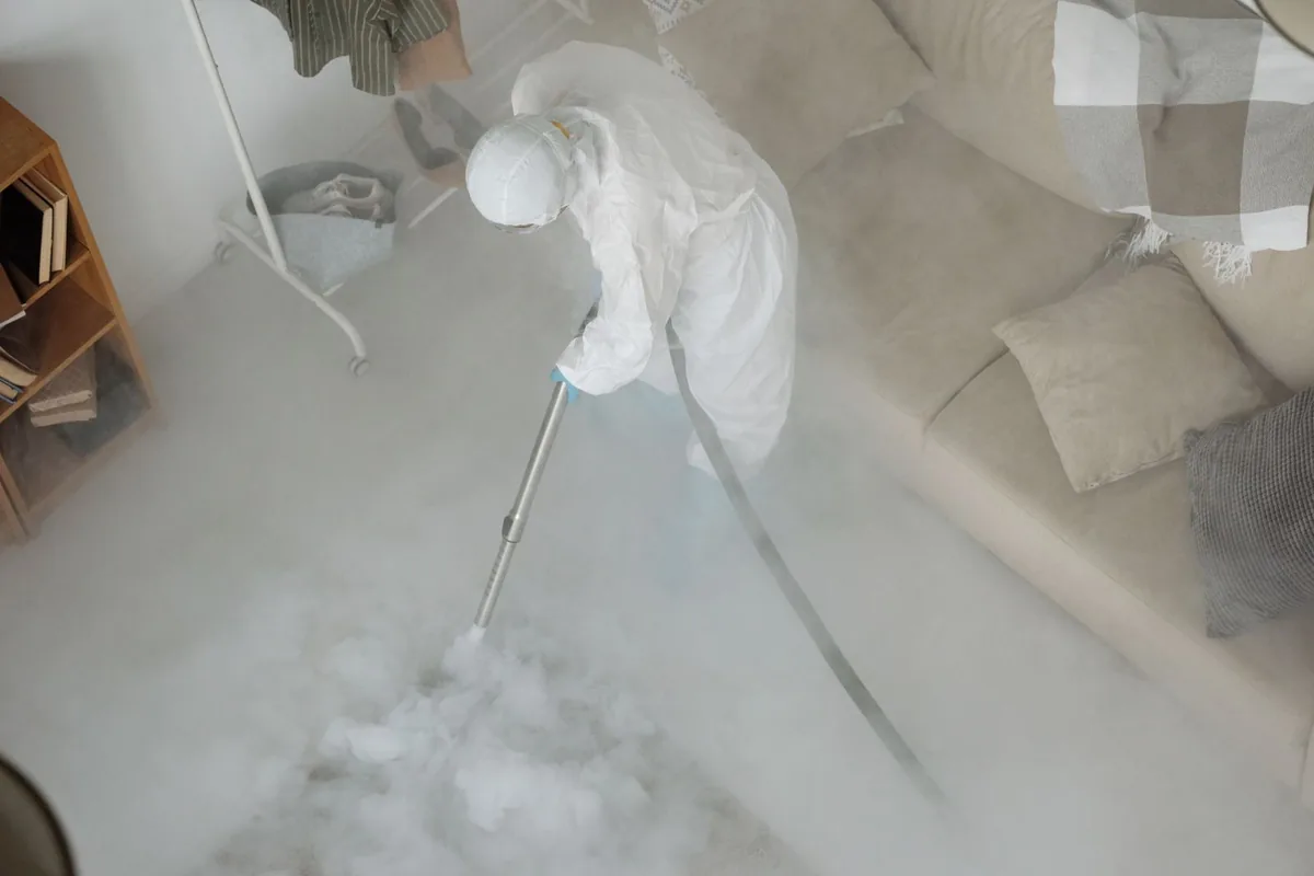Biohazard cleanup technician in protective equipment, Colchester, CT